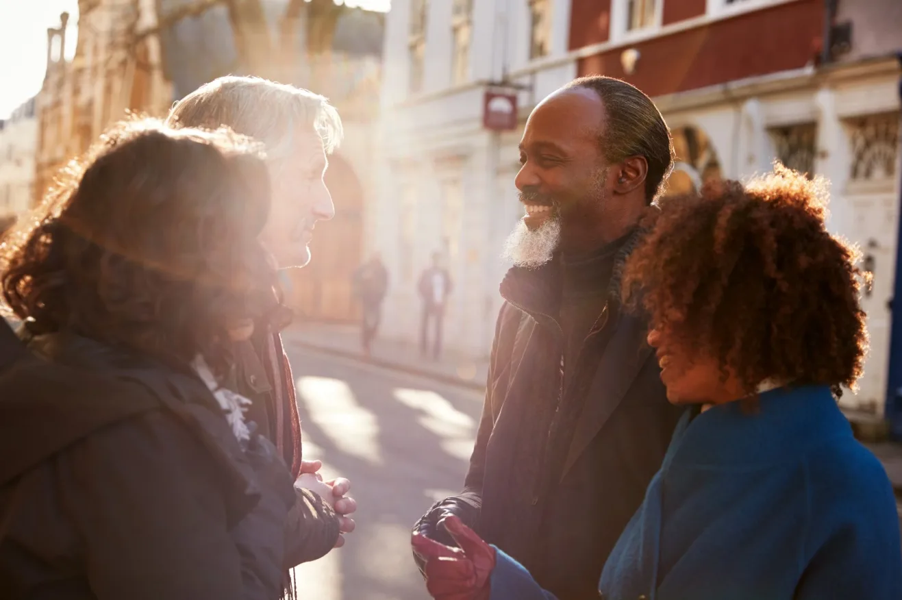 Older adults in warm sunlight, smiling